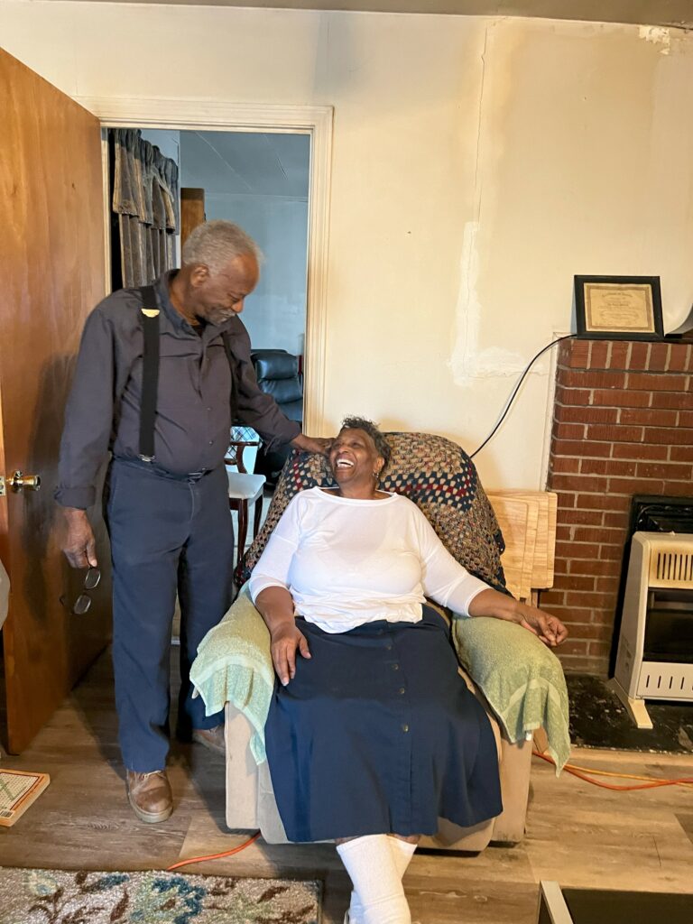 The Gaines smile for a photo in their living room.